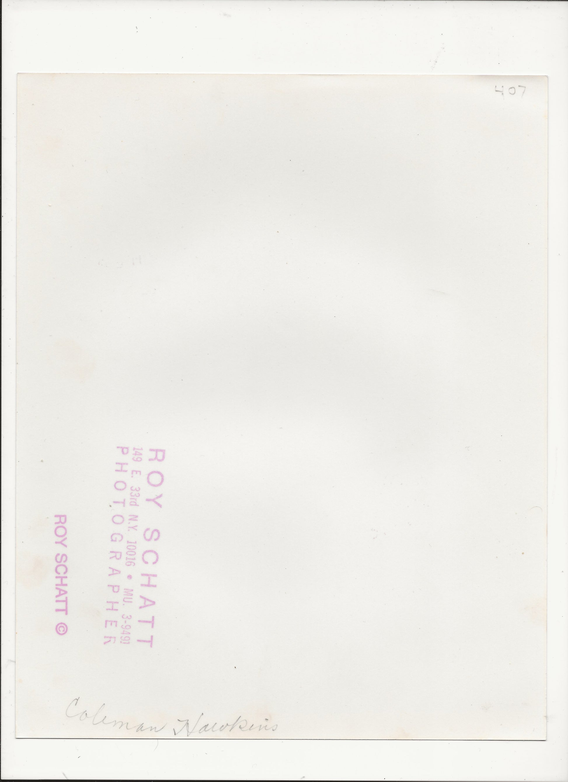 The back of a vintage postcard or photographic print, featuring a white paper background with pink printed text reading 'ROY SCHATT' and a handwritten signature at the bottom.